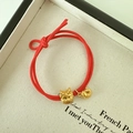 Dettaglio del bracciale rosso intrecciato con pendenti drago dorato e koi per Capodanno - Stile Carattere Fu Testa di Drago (D-4833-3)