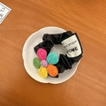Detail of black silk scrunchie with colorful knitted flowers on a white ceramic plate - Purple Heart Large Scrunchie (D-4795-1)