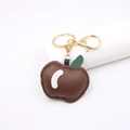 Detailed close-up of brown litchi pattern leather apple keychain with gold metal clasp - Dark Brown