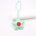 Detail shot of mint green leather flower charm with red center and fine stitching - Green