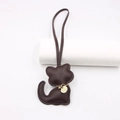 Detail of dark brown leather cat bag charm showing fine stitching and golden metal nameplate - Lanyard Cat / Brown
