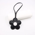 Detail of black cherry blossom leather bag charm with white center and stitching - Black