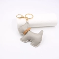 Detail of grey leather Schnauzer keychain with fine stitching and golden metal clasp - Gray
