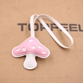 Close-up of pink mushroom charm with fine stitching and white leather strap - Pink