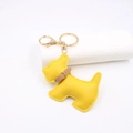 Detail shot of bright yellow leather schnauzer dog keychain with golden hardware - Yellow