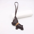 Detail of dark brown leather French Bulldog charm with gold metal clasp and long lanyard - Brown
