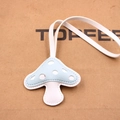 Detail of handcrafted blue and white mushroom leather pendant with fine stitching - Blue