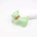 Close-up of light green leather puppy bag charm with yellow stitching and gold metal buckle - Light Green