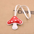 Detail of a handmade red and white mushroom leather pendant with fine white stitching - Red