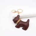 Detailed close-up of dark brown leather Scottish Terrier dog keychain with golden hardware - Brown