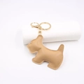 Dettaglio portachiavi a forma di cane Schnauzer in pelle beige con cuciture bianche - Cachi