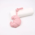 Close-up of pink leather croissant bag charm with detailed stitching on white background - Pink