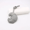 Close-up of grey leather croissant-shaped charm with white contrast stitching details - Gray