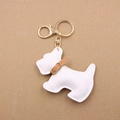 Detail view of white leather Schnauzer dog keychain with gold metal lobster clasp - White