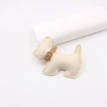 Close-up of cream leather dog charm featuring lychee grain texture and fine stitching - Off-white