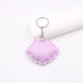 Close-up of light purple leather shell keychain with lychee grain and silver metal ring - Taro Purple