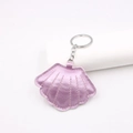 Metallic pink seashell leather keychain with silver ring on a white display stand - Pearlescent Taro Purple