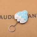 Detail shot of a blue strawberry leather keychain with white dots and silver metal ring - Strawberry Shape / Light Blue
