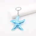 Portachiavi a forma di stella marina olografica blu in pelle con anello in metallo - Blu Iridescente