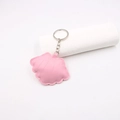 Macro detail of a pink leather shell-shaped keychain with neat stitching and silver ring - Pink
