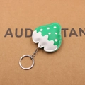 Detailed view of handmade strawberry leather keychain with white polka dots and metal ring - Strawberry Shape / Green