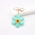 Minzgrüner Sonnenblumen-Schlüsselanhänger aus Leder mit goldenem Ring für Taschen - Sonnenblume Stil / Grün