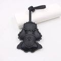 Close-up of black leather poodle bag charm showing fine stitching and embossed facial details - Black