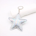 Detailed macro view of holographic star keychain with crocodile texture and silver chain - Metallic Silver