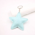 Close-up of a light blue pleated leather star keychain with a metallic silver ring - Teal
