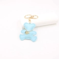 Close-up of blue leather bear keychain with hand-stitched edges and golden hardware - Bear / Blue