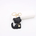 Detailed view of black faux leather cat keychain with gold chain and lobster clasp - Black