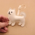 Cute cream leather pomeranian dog bag charm with hand-stitched details and litchi texture - Beige