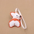 Detail of a handmade leather Corgi puppy bag charm with white and orange stitching - Orange