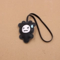 Close-up of cloud-shaped black leather bag charm with embroidered sweating face detail - Grass Black
