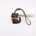 Detail of dark brown leather cat bag charm with tan bow and contrast stitching - Lanyard Bow Cat / Brown