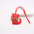 Detail of red leather cat bag charm with lychee texture and khaki bowtie knot - Lanyard Bow Cat / Red