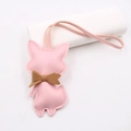 Close-up of pink leather fox charm with brown bowknot and visible stitching detail - Lanyard Bow Fox / Pink