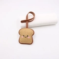 Cute toast bread bag tag made of brown leather with a smiling face and leather strap - Wheat