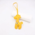 Close-up of yellow leather giraffe bag charm with detailed stitching and gold chain - Yellow