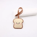 Cute toasted bread leather bag charm with smiling face and woven texture on white background - Off White