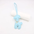 Detail of blue leather giraffe charm featuring gold chain and circular metal pendant - Blue