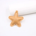 Detail view of a star-shaped leather pendant with fine stitching and top loop - Star Accessories / Khaki