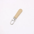 Detail of beige leather zipper pull with silver metal swivel lobster clasp and stitching - Khaki