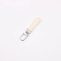 Close-up of cream leather zipper pull with silver rotating lobster clasp for DIY bags - Off-white
