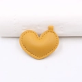 Detail of yellow lychee grain leather heart pendant with fine stitching and top loop accessory - Orange