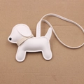 Detailed view of a white leather dog bag charm with stitching on a cardboard background - White - Beige Collar