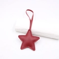 Detail of red leather star-shaped bag charm with lychee texture and stitching - Star Lanyard / Burgundy