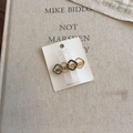 Detail of a gold geometric hair clip with blue enamel circles on a rustic linen background - Blue Square (D-5961-7)