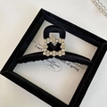 Detailed close-up of a luxury black velvet hair claw clip with a sparkling crystal center - Large Large Square Rhinestone