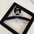 Detailed view of black velvet hair claw clip with a sparkling crystal buckle in a gift box - Large Small Square Rhinestone